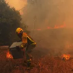 Yangın dumanıyla kaplanmış bir manzarada çocuk silüeti